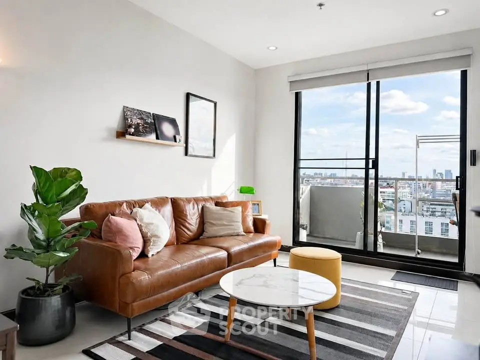 Stylish living room with leather sofa and city view balcony in modern apartment