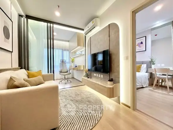 Modern living room with stylish decor and open layout leading to a cozy bedroom, perfect for urban living.