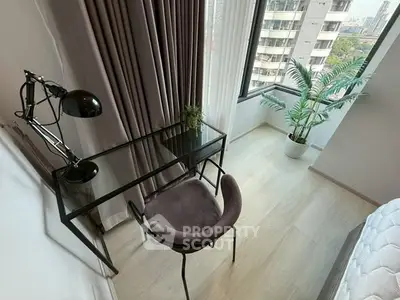 Modern study area with glass desk and city view in high-rise apartment