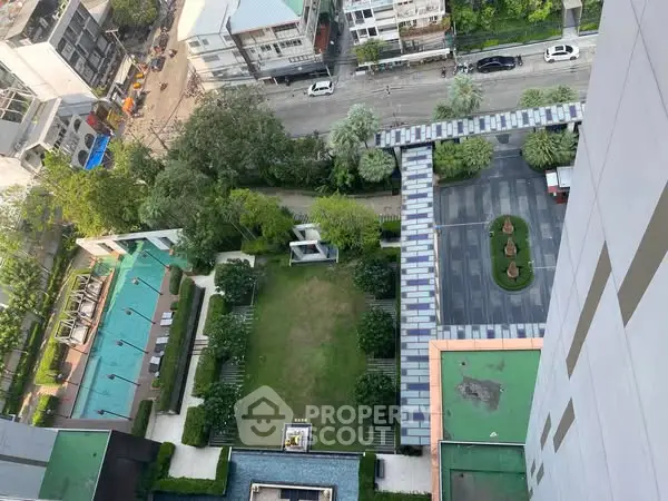 Stunning aerial view of urban residential area with lush gardens and swimming pool.