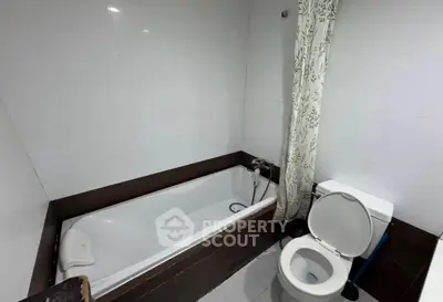 Modern bathroom with bathtub and toilet in sleek design