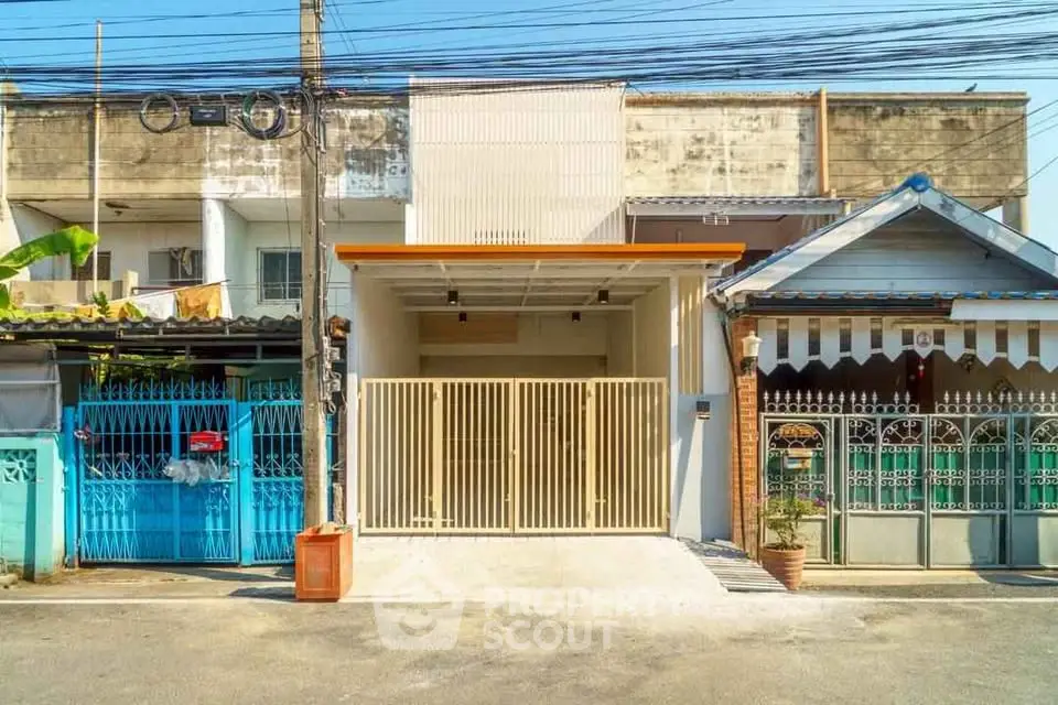 Charming urban townhouse with gated entrance and modern facade in vibrant neighborhood.