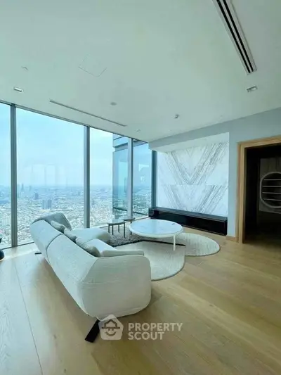 Luxurious modern living room with panoramic city views and elegant furnishings.