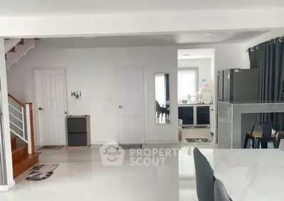 Modern open-plan kitchen and dining area with sleek design and ample natural light.