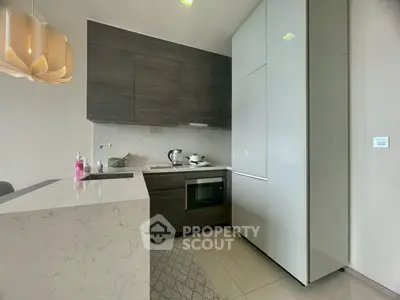 Modern kitchen with sleek cabinetry and built-in appliances in a stylish apartment.