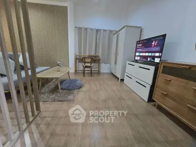 Modern living room with stylish furniture and TV, perfect for relaxation and entertainment.