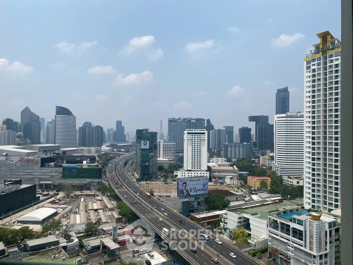 Stunning cityscape view showcasing modern skyscrapers and bustling highway, perfect for urban living enthusiasts.