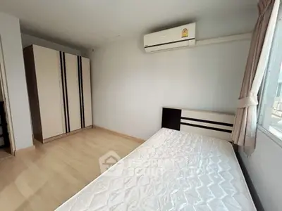 Spacious bedroom with air conditioning and large wardrobe