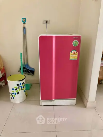 Chic pink refrigerator in a modern kitchen setting, perfect for vibrant home decor.