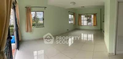 Spacious empty living room with large windows and tiled flooring