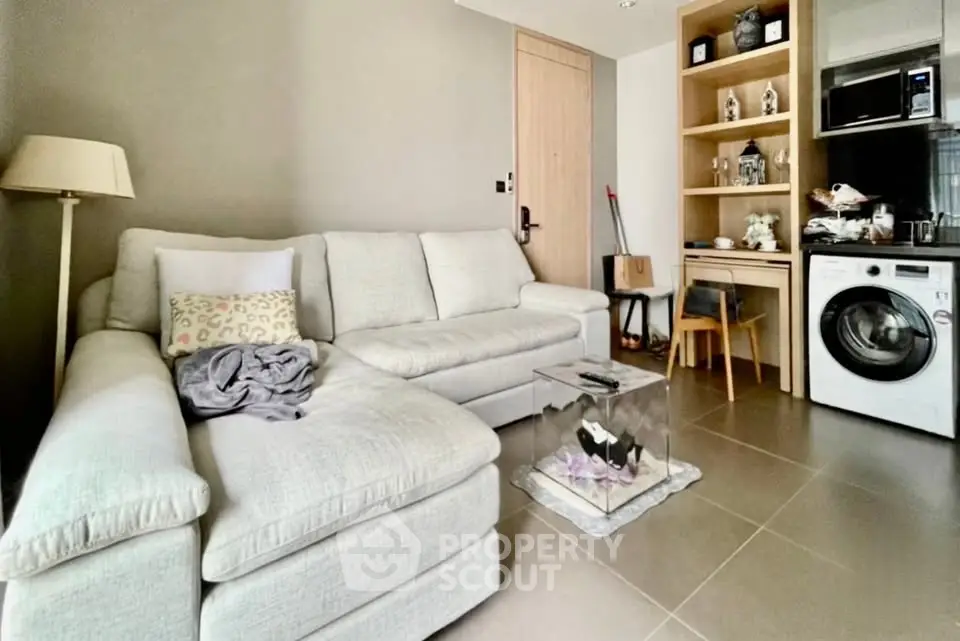 Modern living room with cozy sectional sofa and integrated kitchen appliances