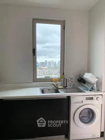 Modern kitchen with city view and washing machine, sleek design