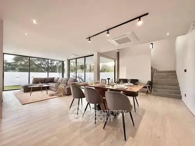 Spacious modern living and dining area with large windows and elegant decor