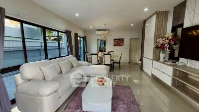 Spacious living room with elegant decor and large windows in modern home