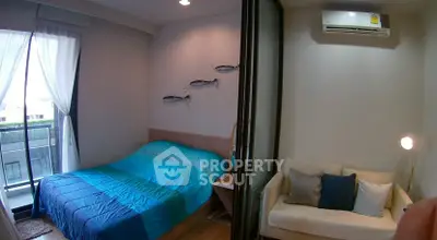 Cozy bedroom with balcony access and modern decor in a stylish apartment.