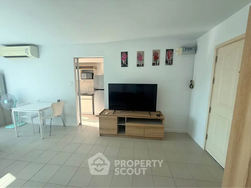 Spacious living room with modern decor and open kitchen layout