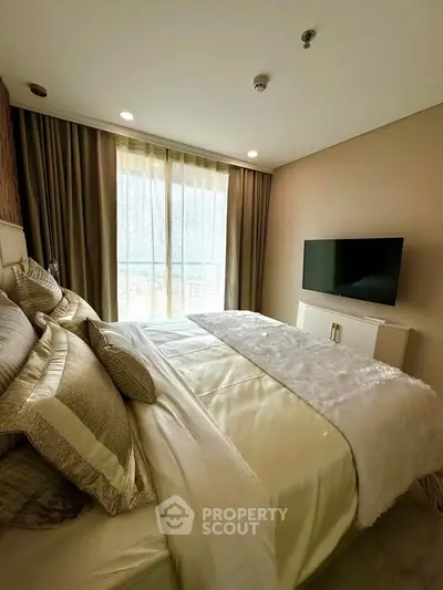 Luxurious bedroom with elegant decor and large window offering natural light