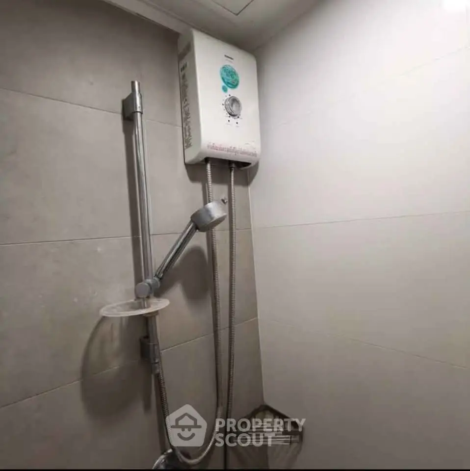 Modern bathroom with sleek shower and water heater, ideal for comfort and convenience.