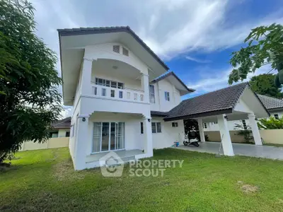 Charming two-story white house with spacious lawn and modern architecture.