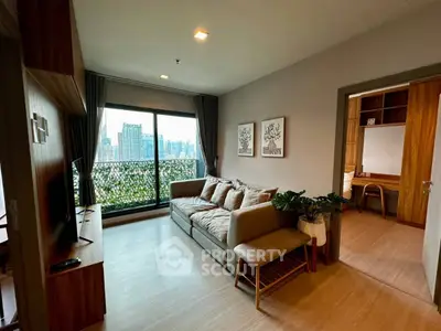Modern living room with city view, cozy sofa, and stylish decor in a high-rise apartment.