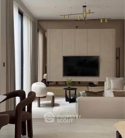 Luxurious modern living room with elegant furniture and large TV, perfect for relaxation and entertainment.