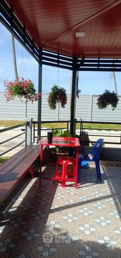 Charming outdoor patio with vibrant flowers and cozy seating area