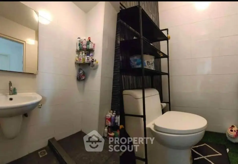 Modern bathroom with sleek fixtures and ample storage space.