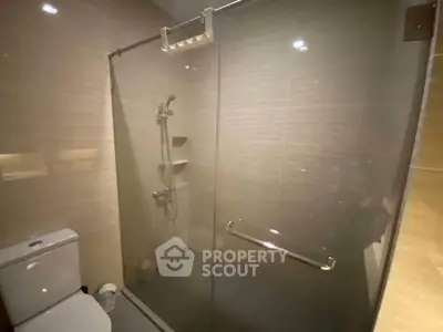 Modern bathroom with glass shower enclosure and sleek fixtures