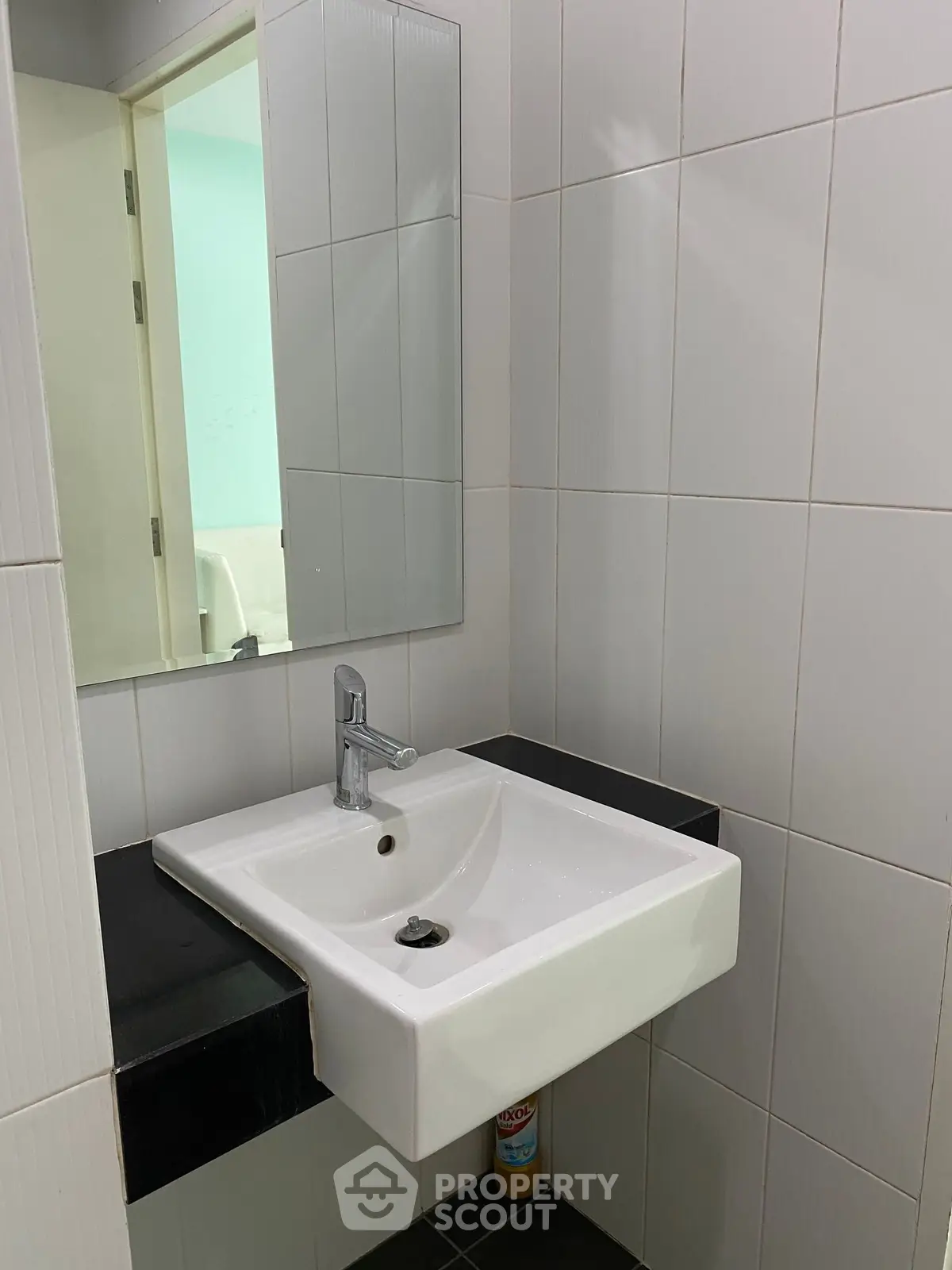 Modern bathroom with sleek white sink and mirror, ideal for contemporary living spaces.