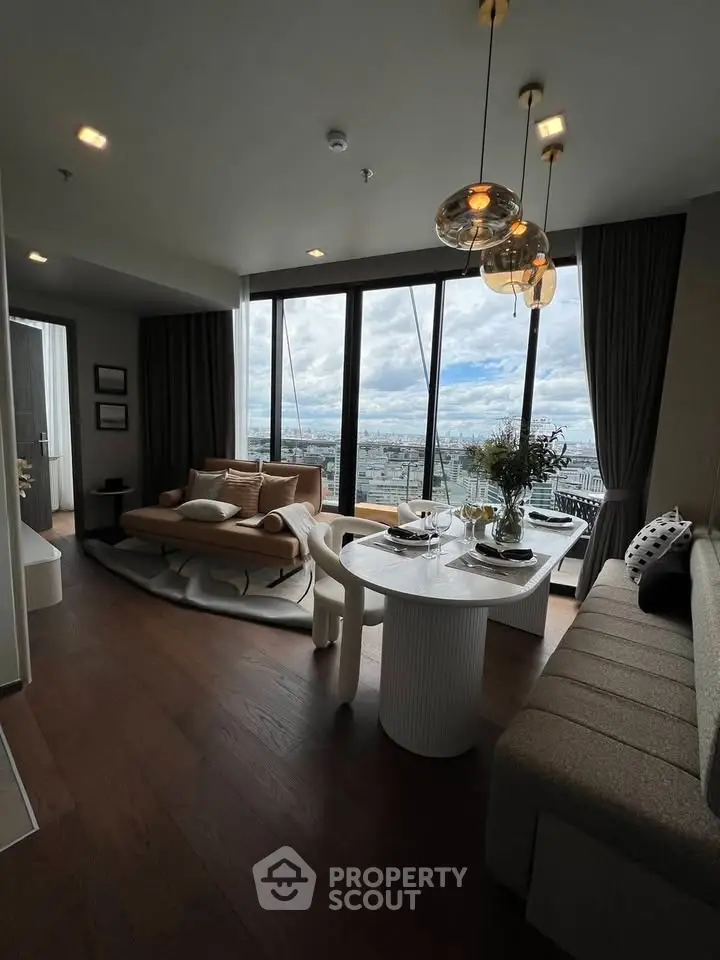 Luxurious living room with panoramic city view, elegant decor, and modern furniture in high-rise apartment.