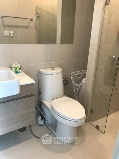 Modern bathroom with sleek fixtures and glass shower enclosure
