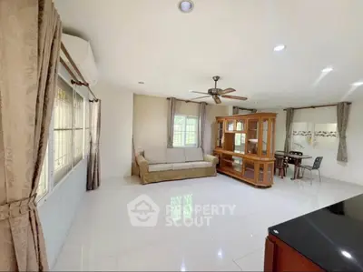 Spacious living room with elegant furniture and large windows for natural light.