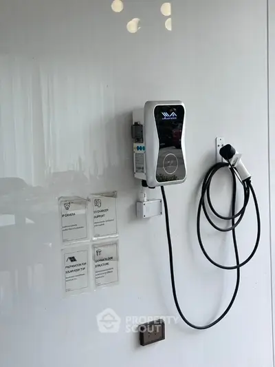 Modern electric vehicle charging station in sleek residential garage setting.