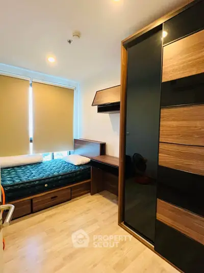 Modern bedroom with sleek wooden furniture and ample natural light