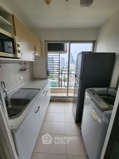 Modern kitchen with city view, featuring sleek appliances and ample counter space.