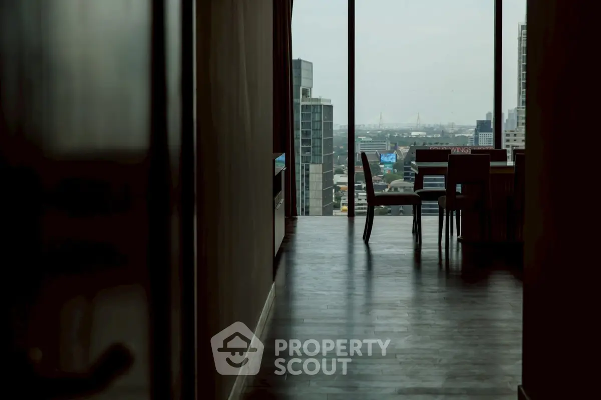 Stunning city view from a modern high-rise apartment with sleek interior design.