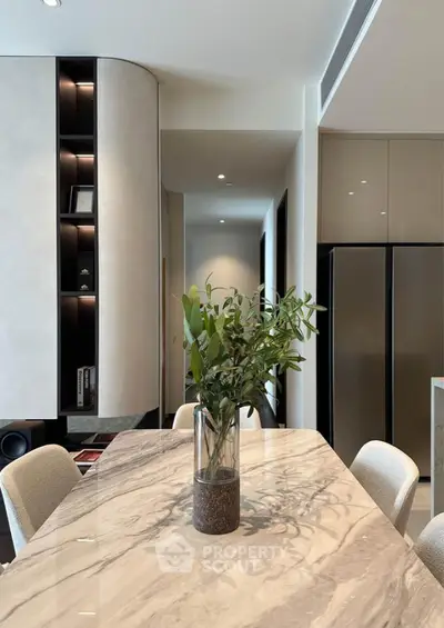 Modern dining area with marble table and sleek cabinetry