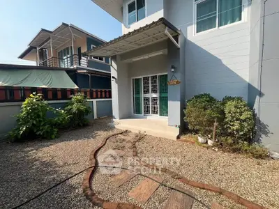 Charming modern house exterior with gravel pathway and lush greenery