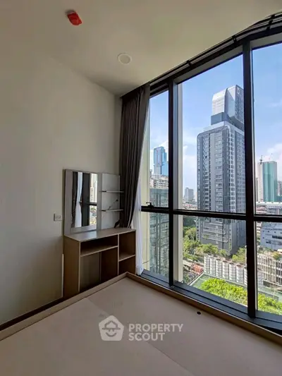 Modern bedroom with stunning city view from floor-to-ceiling windows.