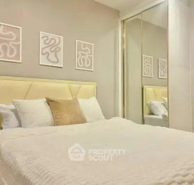 Cozy bedroom with modern decor and mirrored closet doors.