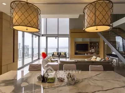 Luxurious open-plan living room with stunning city view and modern decor.