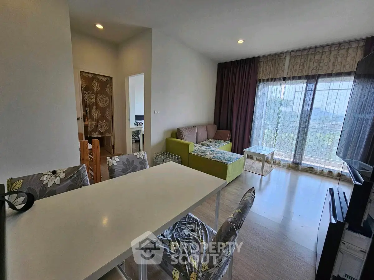 Modern living room with stylish decor and large windows offering natural light.