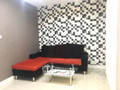 Modern living room with stylish black and red sofa and geometric wall design