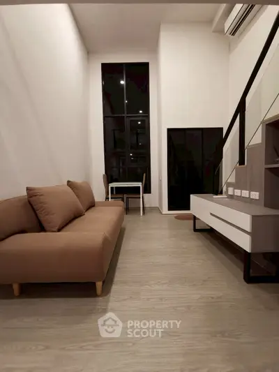 Modern living room with high ceiling and stylish furniture