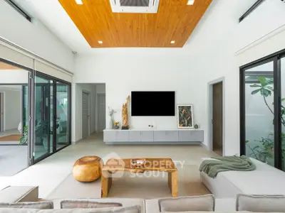 Luxurious modern living room with wooden ceiling and large windows