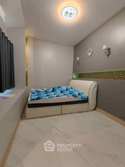 Modern bedroom with stylish lighting and cozy bed in contemporary apartment.