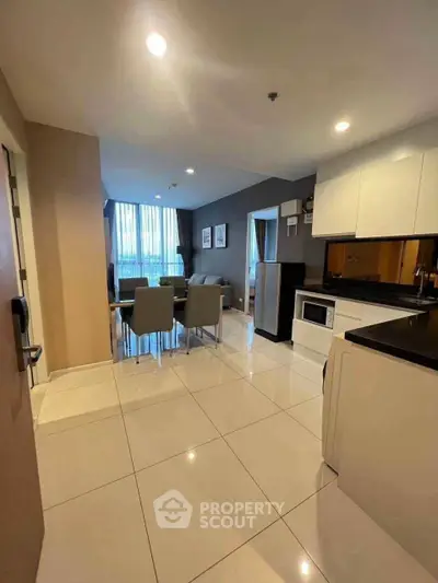 Modern open-layout kitchen and dining area with sleek design and ample natural light.