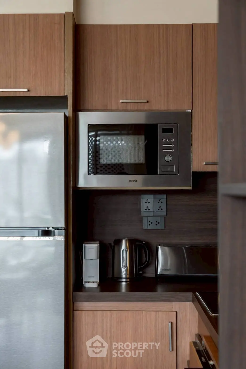 Modern kitchen with stainless steel appliances and wooden cabinetry