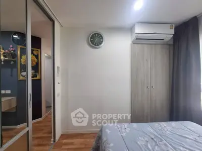 Cozy bedroom with modern decor and air conditioning in a stylish apartment.