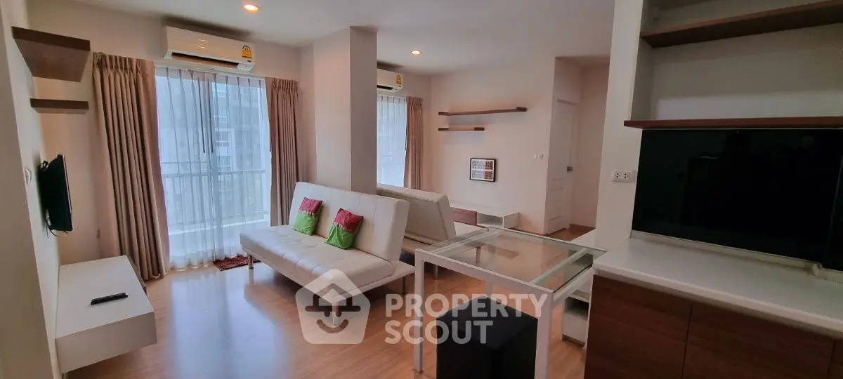 Modern living room with sleek furniture and large windows in a stylish apartment.